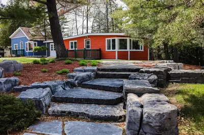 a garden with rocks in front of a house at Fiddlers Green Cottage Two in Wasaga Beach