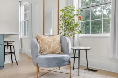 a chair and a table in a room with a window at Beautiful Lakeside Haven in Port Hope