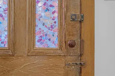 a wooden door with a stained glass window at Beautiful Lakeside Haven in Port Hope