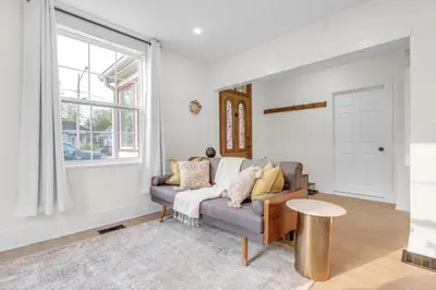 a living room with a couch and a table at Beautiful Lakeside Haven in Port Hope