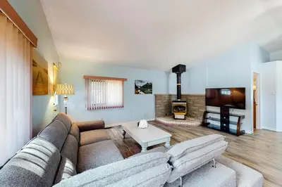 a living room with a couch and a fireplace at The Gardenhouse Cottage One in Wasaga Beach