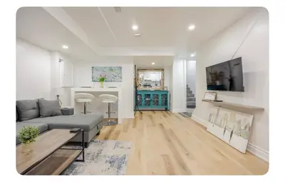 a living room with a couch and a tv at LUXURIOUS 1000 SQ FT Oasis in Brampton