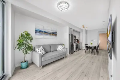a living room with a couch and a table at Luxury Downtown Toronto 2 Bedroom Suite with City and Lake Views and Free Parking in Toronto