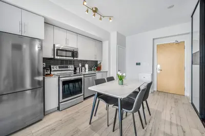 a kitchen with a table and chairs in a room at Luxury Downtown Toronto 2 Bedroom Suite with City and Lake Views and Free Parking in Toronto