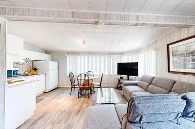 a living room with a couch and a table at The Dockhouse Cottage Five in Wasaga Beach