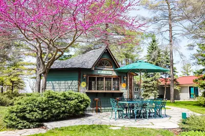 a table and chairs in front of a house at The Dockhouse Cottage Five in Wasaga Beach