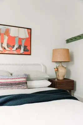 a bedroom with a white bed with a painting on the wall at Town & Trail - Walkable Wellington Charmer in Wellington