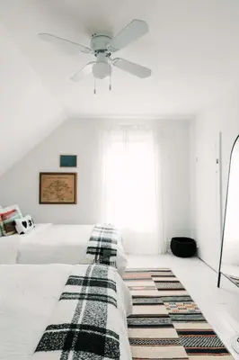 a bedroom with a bed with a ceiling fan at Town & Trail - Walkable Wellington Charmer in Wellington