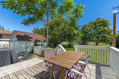 a wooden table and chairs on a deck at Town & Trail - Walkable Wellington Charmer in Wellington