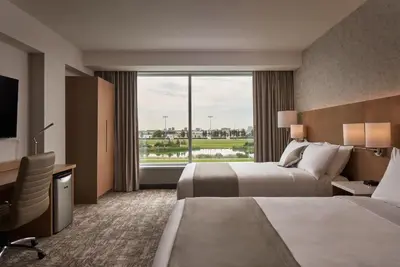a hotel room with two beds and a large window at Great Canadian Casino Resort Toronto in Toronto