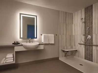 a bathroom with a sink and a mirror and a shower at Great Canadian Casino Resort Toronto in Toronto