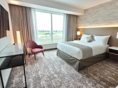 a hotel room with a bed and a window at Great Canadian Casino Resort Toronto in Toronto