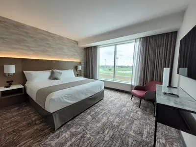a hotel room with a bed and a large window at Great Canadian Casino Resort Toronto in Toronto