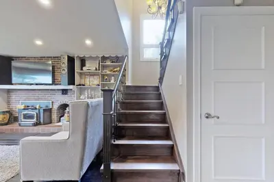 a stairway leading up to a kitchen with a stair case at Hidden Farm Escape in the Heart of Kawarthas in Beaverton