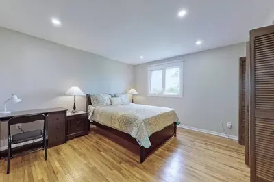 a bedroom with a bed and a desk and a window at Hidden Farm Escape in the Heart of Kawarthas in Beaverton