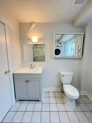 a bathroom with a toilet and a sink at Letitia Heights !B Spacious and Quiet Private Bedroom with Shared Bathroom in Barrie