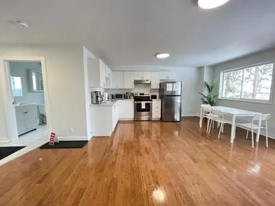 an empty kitchen and living room with a table and chairs at Letitia Heights !B Spacious and Quiet Private Bedroom with Shared Bathroom in Barrie