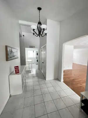 a living room with white walls and a chandelier at Letitia Heights !E Spacious and Quiet Private Bedroom with Private Bathroom in Barrie