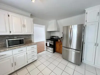 a kitchen with white cabinets and a stainless steel refrigerator at Letitia Heights !E Spacious and Quiet Private Bedroom with Private Bathroom in Barrie