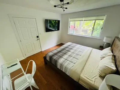 a bedroom with a bed and a window at Letitia Heights !F Spacious and Stylish Private Bedroom with Shared Bathroom in Barrie