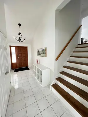 a staircase in a house with a stair case at Letitia Heights !F Spacious and Stylish Private Bedroom with Shared Bathroom in Barrie