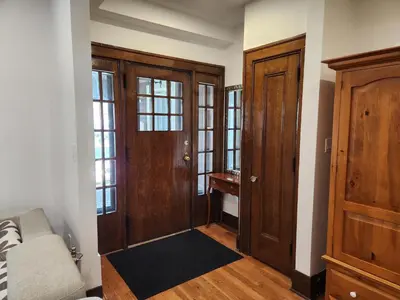 a living room with wooden doors and a couch at Classic Home in Niagara Falls