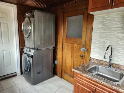 a kitchen with a stainless steel refrigerator and a sink at Classic Home in Niagara Falls