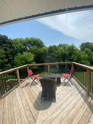 a patio with a table and chairs on a deck at Centre Gate House Licence# 117-2023 in Niagara on the Lake