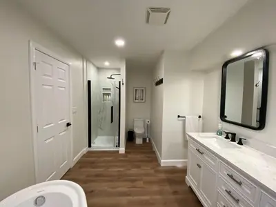 a bathroom with a toilet and a sink and a mirror at Centre Gate House Licence# 117-2023 in Niagara on the Lake