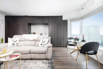 a living room with a couch and a table at Luxury 3-Beds Apartment in Yorkville with the Best City View in Downtown Toronto in Toronto