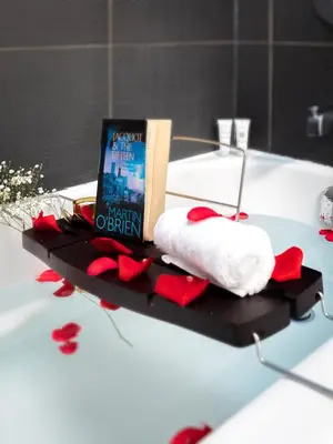 a bathroom with a book and red roses on a table at Luxury 3-Beds Apartment in Yorkville with the Best City View in Downtown Toronto in Toronto