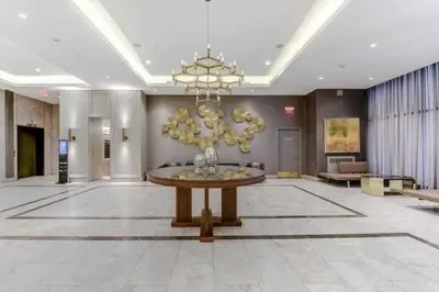 a large lobby with a table and a chandelier at Luxury 3-Beds Apartment in Yorkville with the Best City View in Downtown Toronto in Toronto