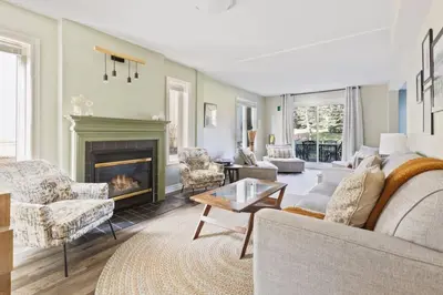 a living room with a couch and a fireplace at 3BR Bright Mountain View Condo at Blue on Monterra in Blue Mountains