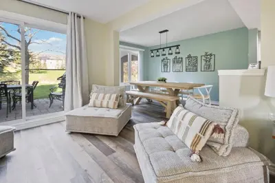 a living room with a couch and a table at 3BR Bright Mountain View Condo at Blue on Monterra in Blue Mountains