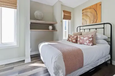 a bedroom with a bed with pillows on it at 3BR Bright Mountain View Condo at Blue on Monterra in Blue Mountains