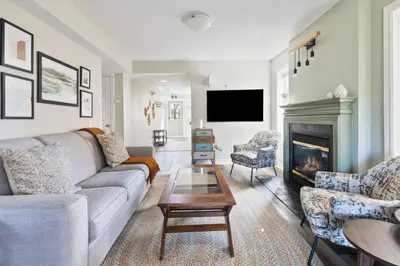 a living room with a couch and a fireplace at 3BR Bright Mountain View Condo at Blue on Monterra in Blue Mountains
