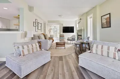 a living room with two couches and a tv at 3BR Bright Mountain View Condo at Blue on Monterra in Blue Mountains