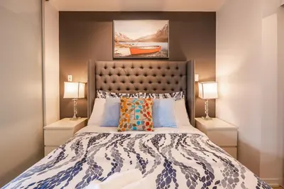 a bedroom with a large bed with two lamps at 1BR Luxury Condo - Downtown Toronto in Toronto