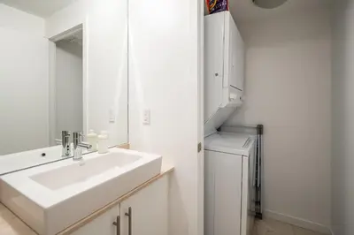 a white bathroom with a sink and a mirror at 1BR Luxury Condo - Downtown Toronto in Toronto