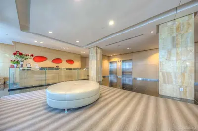 a large room with a white ottoman in the middle at 1BR Luxury Condo - Downtown Toronto in Toronto