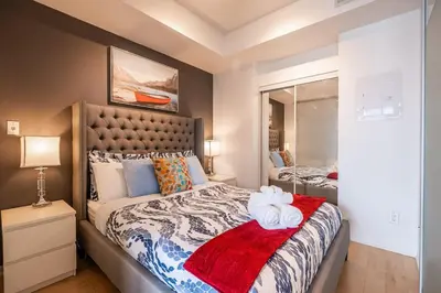 a bedroom with a bed with two towels on it at 1BR Luxury Condo - Downtown Toronto in Toronto