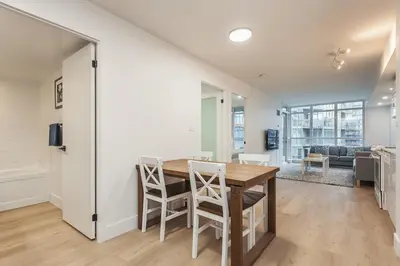 a kitchen and dining room with a table and chairs at Cozy 2BR Close to CN Tower & Harbourfront in Toronto