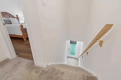 a room with a staircase with a bed and a window at Konia Suites in Orangeville