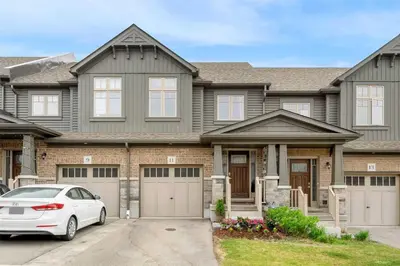a house with a car parked in front of it at Konia Suites in Orangeville