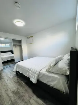 a bedroom with a large bed in a room at Konia Suites in Orangeville