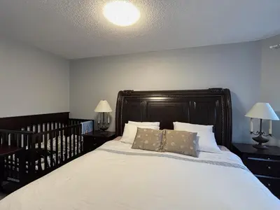 a bedroom with a large bed with white sheets and pillows at Lake Simcoe 4 Bedroom Family Home Ideal Toronto Area Retreat in Innisfil