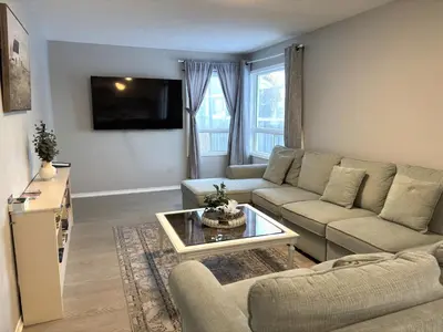 a living room with a couch and a table at Lake Simcoe 4 Bedroom Family Home Ideal Toronto Area Retreat in Innisfil