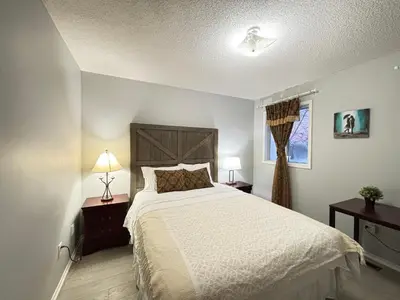 a bedroom with a large bed and two night stands at Lake Simcoe 4 Bedroom Family Home Ideal Toronto Area Retreat in Innisfil