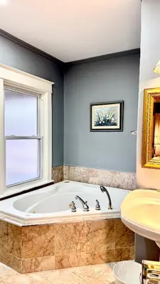 a bathroom with a tub and a window and a sink at Two bedrooms unit with jacuzzi and great view in Niagara Falls
