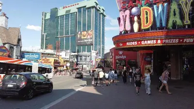a busy city street with people walking on the street at Two bedrooms unit with jacuzzi and great view in Niagara Falls